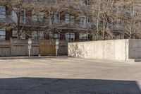 a person is jumping on a skateboard in the air near a parking lot with buildings