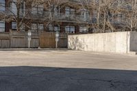 a person is jumping on a skateboard in the air near a parking lot with buildings