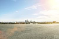 a skateboarder standing on the street near the cityscape of a big city