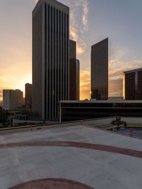 skateboarder on top of roof in urban setting with high - rise buildings in the background