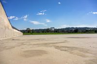 skateboarder performing trick on empty skate ramp at park area in urban setting in open area