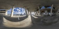 a skateboarder riding on a big concrete structure with sky in the background of his photo