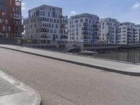 a skateboarder is in the middle of an empty road on a sunny day