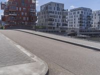 a skateboarder is in the middle of an empty road on a sunny day