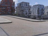 a skateboarder is in the middle of an empty road on a sunny day