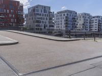 a skateboarder is in the middle of an empty road on a sunny day