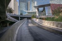 a man riding a skateboard down a long bridge next to high buildings, some with windows and other