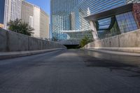 a man riding a skateboard down a long bridge next to high buildings, some with windows and other