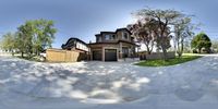 a skateboarder is going down a curved wall in the neighborhood of a house