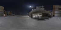 a skateboarder riding a skateboard on a ramp at night time through the back of a skate park