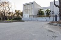 a skateboarder on the street near a building with several windows on both sides