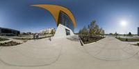 a view from inside the fisheye lens of a skateboarder doing tricks at the park