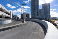 a skateboarder in the middle of a ramp near buildings and lights on a sunny day