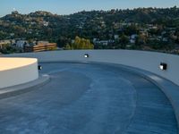 skateboarder is riding along a concrete deck overlooking the city of los angeles below