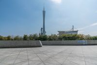 a skateboarder is riding on the concrete skate park area near the space needle