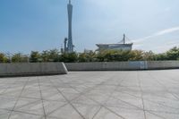 a skateboarder is riding on the concrete skate park area near the space needle