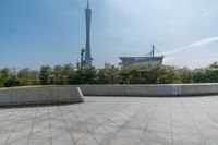 a skateboarder is riding on the concrete skate park area near the space needle