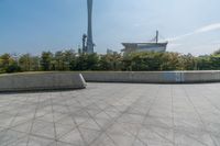 a skateboarder is riding on the concrete skate park area near the space needle