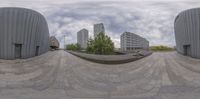 a 360 - shot of a skate boarder riding on a skateboard ramp outside