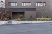 a skate boarder is riding down the middle of an empty street in front of a brown building