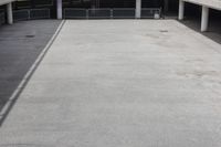 a skateboarder riding underneath an overpass in the city, outside a building