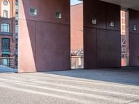 there is a skateboarder riding down a concrete sidewalk in an urban setting on a sunny day