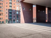 there is a skateboarder riding down a concrete sidewalk in an urban setting on a sunny day