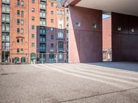 there is a skateboarder riding down a concrete sidewalk in an urban setting on a sunny day