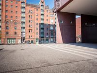 there is a skateboarder riding down a concrete sidewalk in an urban setting on a sunny day