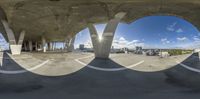 the fisheye view of a skateboarder doing tricks on a ramp outside of a building