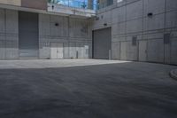 a skateboarder is coming out the door of a storage building while in the foreground it sits a parking area