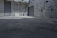 a skateboarder is coming out the door of a storage building while in the foreground it sits a parking area