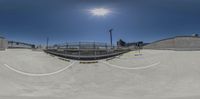 a skateboarder is in the air after hitting a trick on the ramp, at an athletic stadium