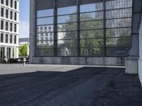 a skateboarder riding a ledge off the ground in front of a tall building