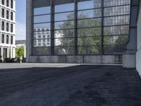 a skateboarder riding a ledge off the ground in front of a tall building