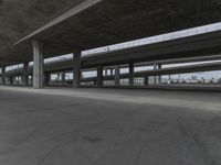 skateboarders are seen in an empty parking lot during the day on a cloudy day