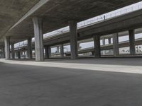 skateboarders are seen in an empty parking lot during the day on a cloudy day