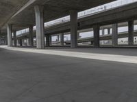 skateboarders are seen in an empty parking lot during the day on a cloudy day