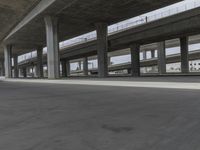 skateboarders are seen in an empty parking lot during the day on a cloudy day