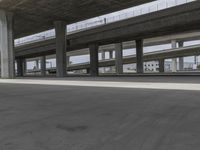 skateboarders are seen in an empty parking lot during the day on a cloudy day