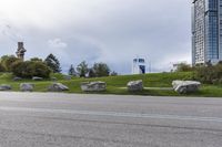 two skateboarders riding along an empty highway, the one is doing a trick