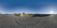 the person has taken a 360 - camera photo on a skateboard near trees and mountains