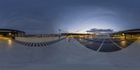 a skateboarder wearing a helmet is riding down a ramp at dusk on his board