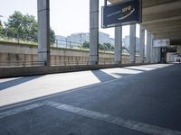 a person riding a skateboard down the street in front of a subway station tunnel