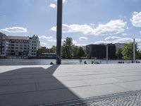 a person with a skateboard in a city setting and the sun is shining on it