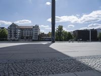 a person with a skateboard in a city setting and the sun is shining on it