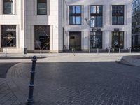 a skateboarder is riding in the middle of a city square of various buildings