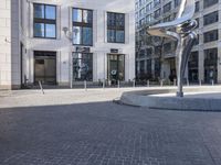 a skateboarder is riding in the middle of a city square of various buildings