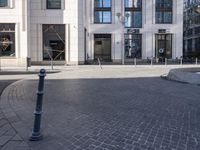 a skateboarder is riding in the middle of a city square of various buildings