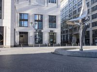 a skateboarder is riding in the middle of a city square of various buildings